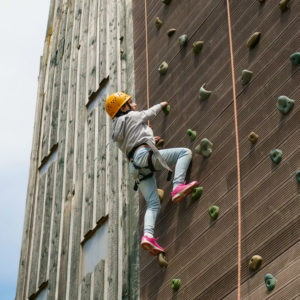 A pupil on the outdoor climbing wall 