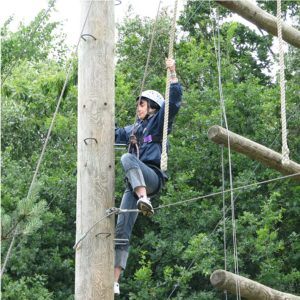A boy on the high ropes course 