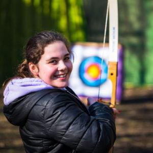  a girl doing archery at Summit Centre 